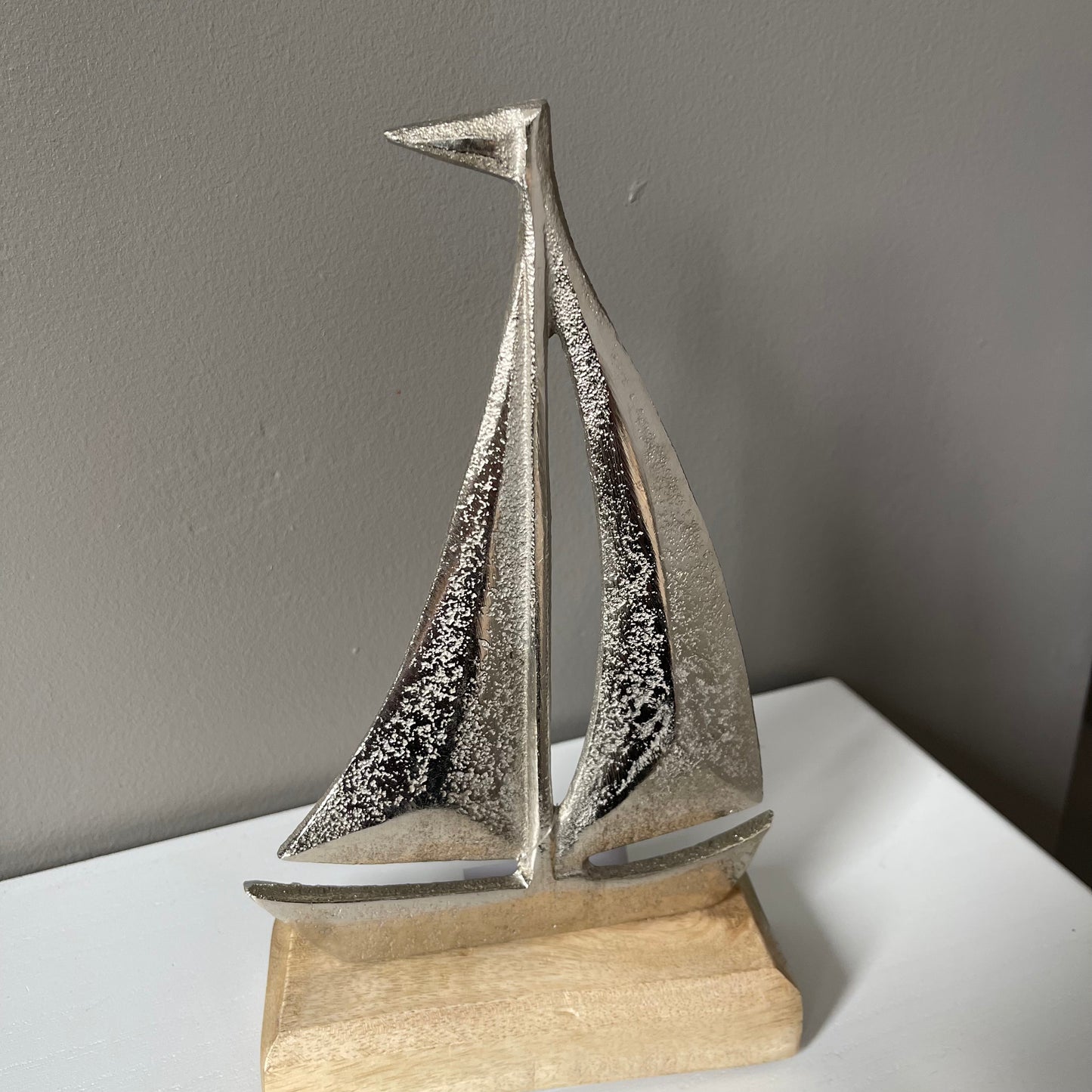 Silver Metal Sailboat on Wooden Base