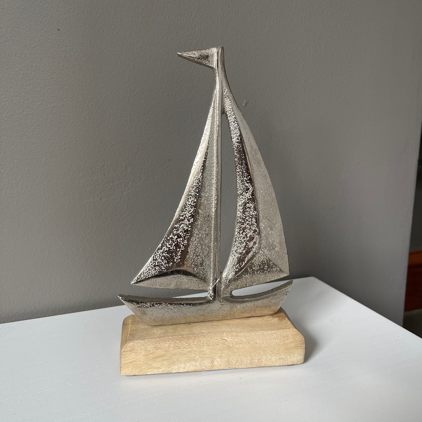Silver Metal Sailboat on Wooden Base